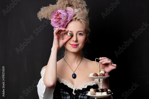 Beautiful blonde countess with chocolate candies