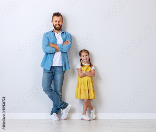 concept of the family. father and child to daughter near empty wall