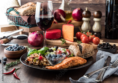 Mediterranean meal including greek salad, seven grain salad, salmon and blueberries. Mediterranean diet concept.