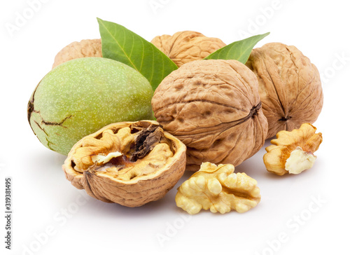 Ripe walnut and leaves isolated on a white background