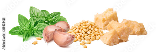 Fresh pesto ingredients, green basil leaves, garlic cloves, parmesan cheese and pine nuts isolated on white background