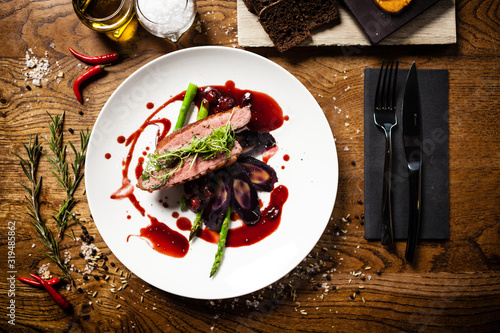 Duck breast served on a plate in restaurant