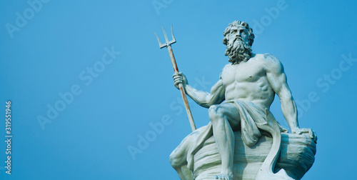 Ancient stone statue of mighty god of the sea and oceans Neptune (Poseidon) with trident.