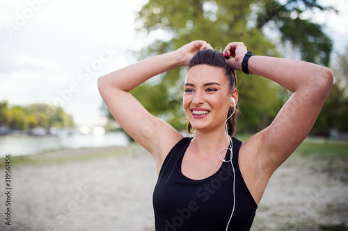 Woman tying hair before running outdoor