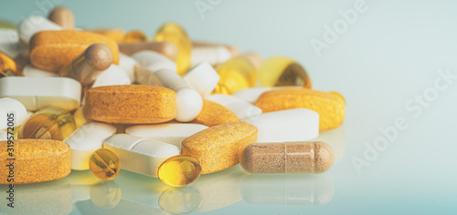 Dietary Supplements macro photo: multivitamin tablets, softgels with Omega-3 and Vitamin D3, antioxidants and capsules with minerals. Homeopathy and alternative organic medications.