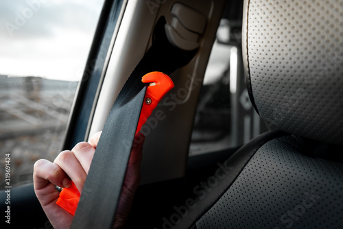 Safety hammer mounting and seatbelt cutter in car use in case accident. 