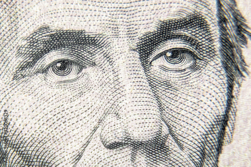 Abraham Abe Lincoln face on 5 dollar bill close up. Detail of new currency note. Macro view of Lincoln eyes on USA paper money.