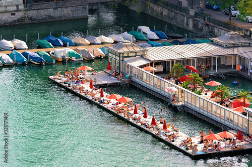 Women beach at Limmat River quay in the city center in Zurich, Swiss