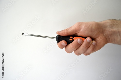 Male's hand holding screwdriver isolated on white background