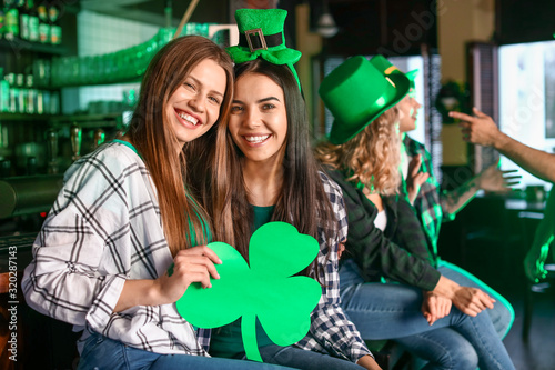 Young women celebrating St. Patrick's Day in pub