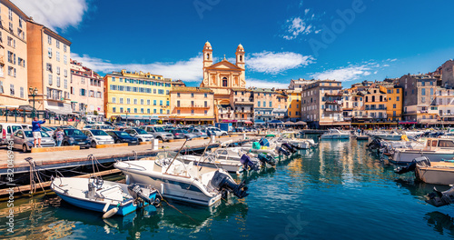Panoramic summer cityscape of Bastia port with twin-towered Church of St. Jean-Baptiste rising behind it. Stunning afternoon view of Corsica island, France, Europe. Bright Mediterranean seascape.