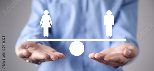 Man showing balance scale. Man and Woman equality