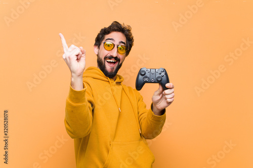 young crazy cool man paying with a game console controller