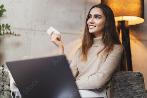 Girl using bank card for buying things online. Retail stores offering bonus cards for customers. Select items in web shop app, transfer money safely using sms code for payment. Money refund guarantee.