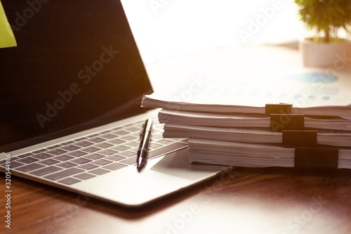 Stack of documents placed on a business desk in a business office.