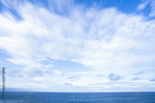Seascape with sea horizon and beautiful sky line with clouds. Blue Ocean and sea with white cloud on blue sky in spring or summer