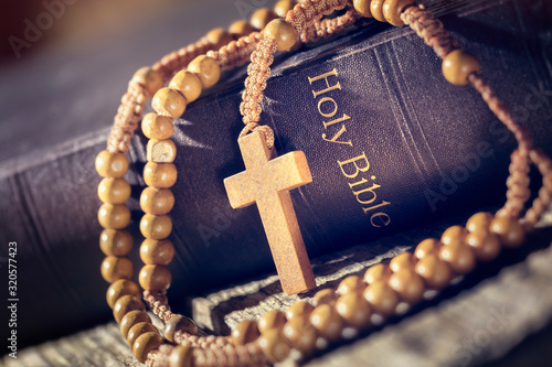 Rosary beads and crucifix cross on holy bible
