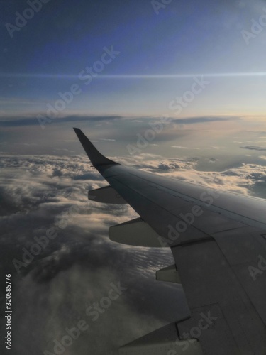 wing of an airplane flying above the clouds