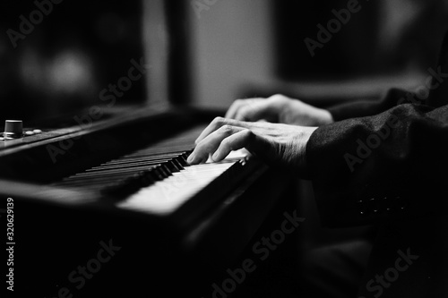 Hands of pianist playing synthesizer close-up