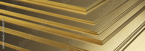 Stack of brass sheets. Rolled metal product, close-up.