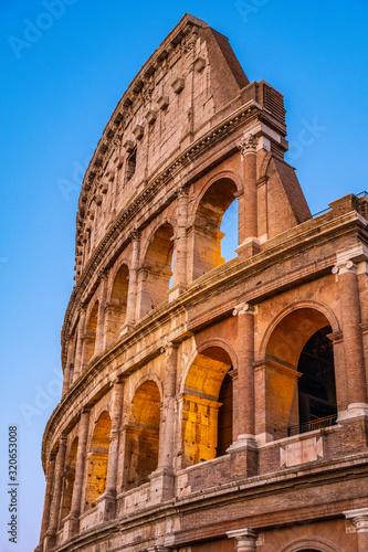 Rome, Italy - External walls of the ancient roman Colosseum - Colosseo - known also as Flavian amphitheater - Anfiteatro Flavio - in an evening light