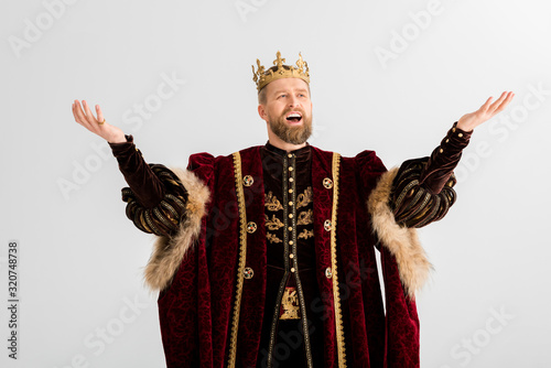 handsome king with crown screaming isolated on grey