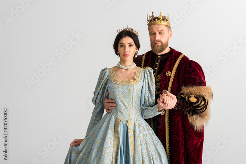 handsome king hugging queen with crown isolated on grey