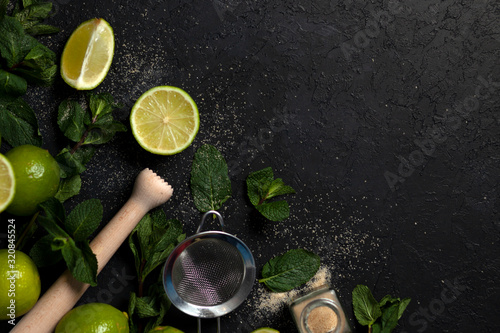 ingredients for making mojito on a dark background, lime, mint, with tools, flat lay for a mojito recipe