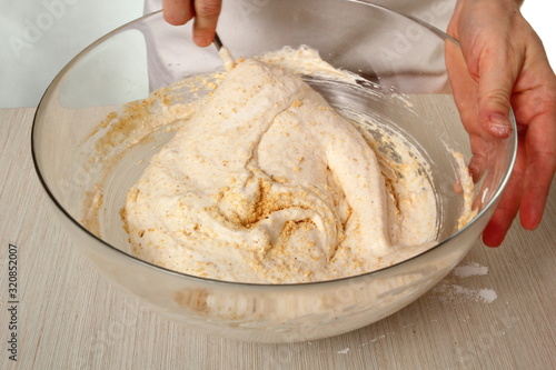 Fold nut mixture into whipped egg whites. Making Chocolate Hazelnut Meringue Cake.