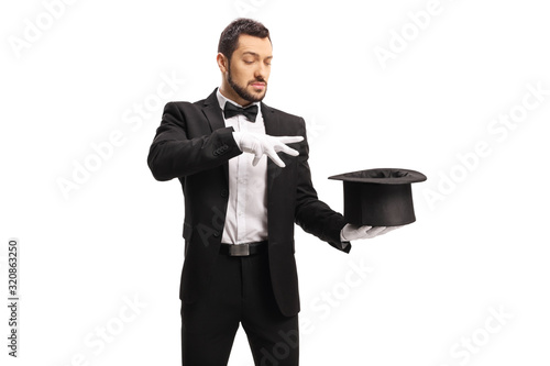 Male magician performing a trick with hands and a top hat