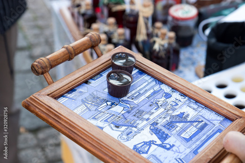 Ginja liquor served on a typical Portuguese ceramic tray