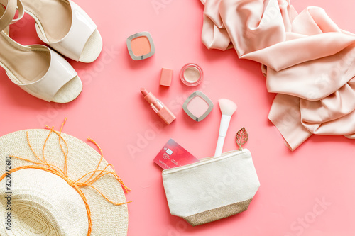 Shopping concept. Women clothes, cosmetics, shoes on pink background top-down
