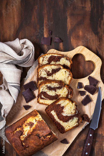 Delicious homemade marble pound cake on wooden background, top view