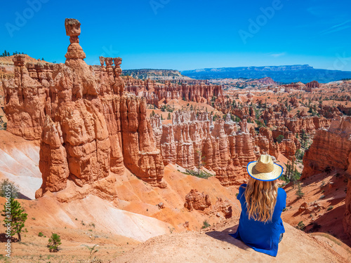 Young woman travels Bryce Canyon national park in Utah, United States, people travel explore nature. Bryce is a collection of giant natural amphitheaters distinctive due Hoodoos geological structures