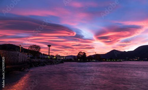 Sunset with spiral clouds over the lake Maggiore