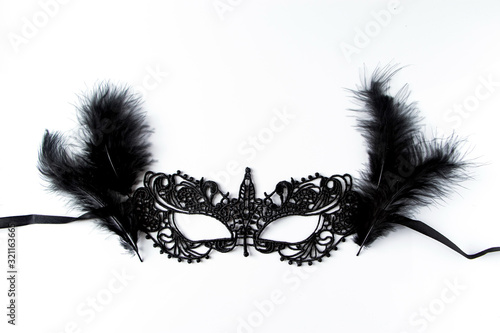 Beautiful carnival mask of black lace on a white background.
