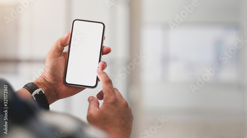 Close up view of a man using blank screen smartphone