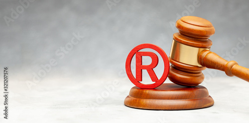 Judge gavel and red trademark sign