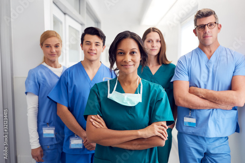 Portrait Of Multi-Cultural Medical Team Standing In Hospital Corridor