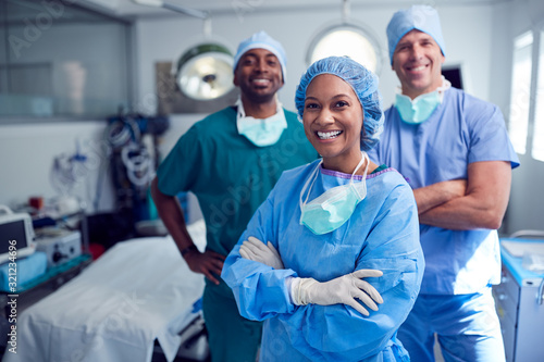 Portrait Of Multi-Cultural Surgical Team Standing In Hospital Operating Theater