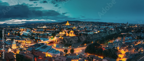 Tbilisi, Georgia. Evening Night View Of Georgian Capital Skyline. Scenic Top View Of Summer Evening Cityscape Of Tbilisi, Georgia In Illumination Lights With All Famous Landmarks, Sightseeings