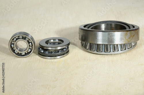 Arrangement with a ball bearing, a thrust bearing, and a tapered roller bearing.