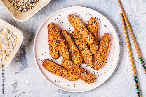 Fried tempeh with sesame seeds.