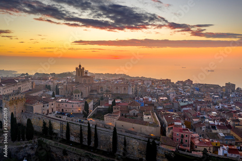 Aerial sunrise view of the medieval walled center of Tarragona in Catalunya Spain with the cathedral, city walls, bastions and towers