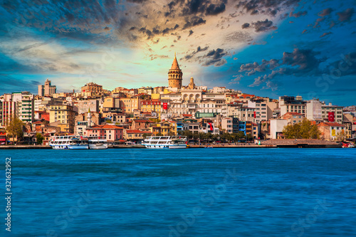 Galata Tower in istanbul City of Turkey. View of the Istanbul City of Turkey with bosphorus, seagulls and boats at bright sky and sunset or night. 