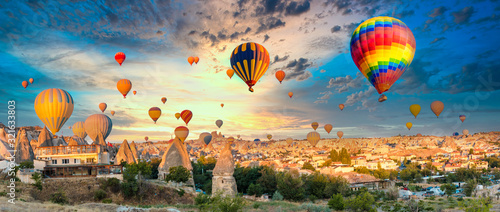 Colorful hot air balloons flying over at fairy chimneys in Nevsehir, Goreme, Cappadocia Turkey. Hot air balloon flight at spectacular Cappadocia Turkey.