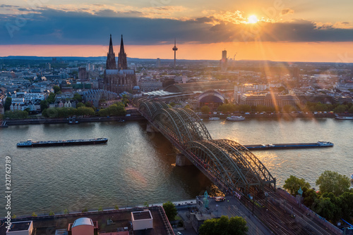 Aerial view of Cologne city, Germany with Cologne Cathedral and Hohenzollern Bridge during sunset