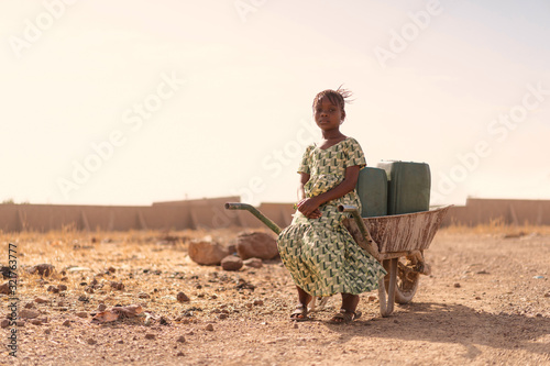 Beautiful Native African Young Girl with Pure Water in a rural village