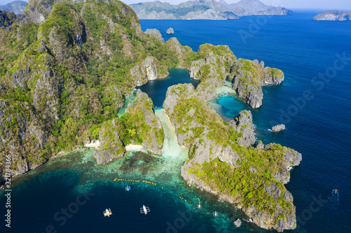 View from above, stunning aerial view of the Big Lagoon and the Small Lagoon, two beautiful bays of crystal clear water. Miniloc Island, Bacuit Bay, El Nido, Palawan, Philippines.