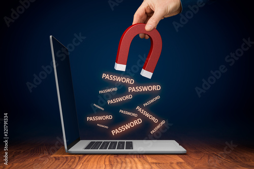 Leaked pwned passwords, data breach, cybersecurity and hacked stolen passwords concepts. Hand with magnet steal passwords from unprotected computer by spyware.